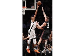 Milwaukee Bucks forward Giannis Antetokounmpo, left, blocks a shot by Brooklyn Nets forward Mitchell Creek (55) during the second half of an NBA basketball game, Monday, Feb. 4, 2019, in New York. The Bucks defeated the Nets 113-94.