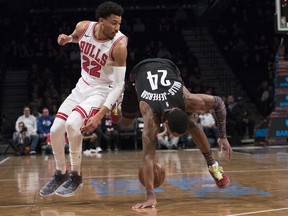 Chicago Bulls Otto Porter Jr. (22) and Brooklyn Nets forward Rondae Hollis-Jefferson (24) vie for a loose ball during the first half of an NBA basketball game Friday, Feb. 8, 2019, in New York.