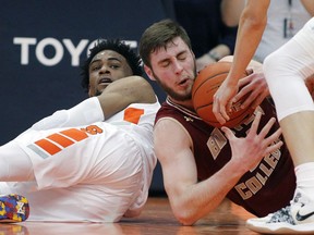 Boston College's Nik Popovic, right, and Syracuse's Oshae Brissett, left, battle for a loose ball during the first half of an NCAA college basketball game in Syracuse, N.Y., Saturday, Feb. 9, 2019.