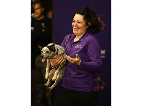 THIS CORRECTS THE LAST NAME TO TOPOL AND NOT TOOL AS ORIGINALLY SENT - Lisa Topol displays her ribbon after winning in the masters agility championship with her dog "Plop" during the Westminster Kennel Club Dog Show, Saturday, Feb. 9, 2019, in New York.