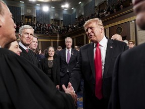 President Donald Trump talks to Supreme Court Chief Justice John Roberts while leaving the House chamber after giving his State of the Union address to a joint session of Congress, Tuesday, Feb. 5, 2019 at the Capitol in Washington.