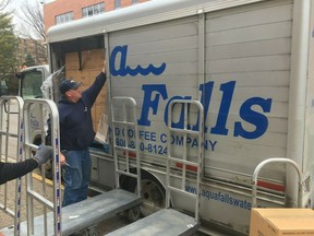 Aqua Falls employees deliver water to University of Dayton Thursday, Feb. 14, 2019 in Dayton, Ohio. A water line broke in one Ohio's largest cities, leaving some 100,000 customers under a boil-water advisory, closing schools and disrupting diners' Valentine's Day plans. (James Rider/WHIO-TV via AP)