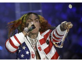FILE- In this Sept. 21, 2018 file photo, rapper Daniel Hernandez, known as Tekashi 6ix9ine, performs during the Philipp Plein women's 2019 Spring-Summer collection during Fashion Week in Milan, Italy. The Brooklyn rapper has pleaded guilty to federal charges, admitting his participation in a violent gang and pledging to cooperate with prosecutors against others.