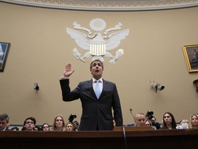 FILE- In this Feb. 27, 2019 file photo, Michael Cohen, President Donald Trump's former personal lawyer, is sworn in to testify before the House Oversight and Reform Committee on Capitol Hill in Washington. Giving Congress a who's who of President Donald Trump's allies and business associates during his testimony, Cohen rattled off more than a dozen names, providing the committee with a potential roadmap for future hearings.