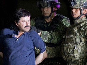 FILE - In this Jan. 8, 2016 file photo, a handcuffed Joaquin "El Chapo" Guzman is made to face the press as he is escorted to a helicopter by Mexican soldiers and marines at a federal hangar in Mexico City. Guzman was tried in New York and found guilty on drug smuggling charges. Claims of jury misconduct arose after a juror told VICE News in February 2019 report that several jurors followed media accounts of the three month-long trial.