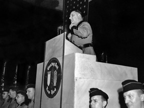 FILE - This Feb. 20,1939 file photo shows Fritz Kuhn, national leader of the Bund, in the full uniform of a Storm Trooper, as he speaks from the rostrum at Madison Square Garden in New York. The pro-Hitler rally that took place 80 years ago this week at New York's Madison Square Garden is the subject of a short documentary that's up for an Oscar this Sunday, Feb. 24, 2019. The film directed by Marshall Curry is called a "A Night at the Garden." (AP Photo, File)
