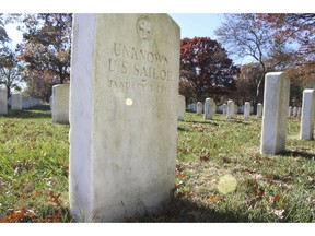 FILE - This Nov. 11, 2016, file photo shows a gravestone, left, with the inscription, "Unknown U.S. Sailor," at Long Island National Cemetery in Farmingdale, N.Y. American Legion officials are calling on New York lawmakers to request the Pentagon exhume the Long Island graves of sailors killed in a World War II ship explosion in an attempt to identify the fallen servicemen.
