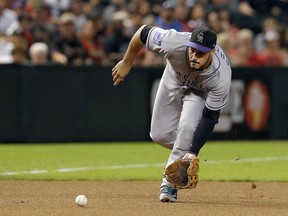 File-This Sept. 21, 2018, file photo shows Colorado Rockies third baseman Nolan Arenado in the first inning during a baseball game against the Arizona Diamondbacks in Phoenix. Arenado likes where he's at and the direction the Colorado Rockies are headed. So he's staying put. For possibly a long, long time. And for a chance to finish what this team has been brewing. The All-Star third baseman agreed to a $260 million, eight-year contract on Tuesday, Feb. 26, 2019, a person familiar with the negotiations told The Associated Press. The person spoke on condition of anonymity because the deal has not been finalized.