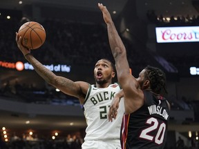 File-This Jan. 15, 2019, file photo shows Milwaukee Bucks' Sterling Brown driving past Miami Heat's Justise Winslow during the second half of an NBA basketball game in Milwaukee. Nearly a year after police fatally shot an unarmed black man in Sacramento and a series of protests ensued in California's capital, the Kings and Milwaukee Bucks collaborated on a daylong summit Wednesday, Feb. 27, 2019, to address social injustice and encourage engagement and thoughtful discussions to try to bring about change. "Whenever the team can do something as big as this for the community, it's important," Brown said after the Bucks' morning shoot-around.