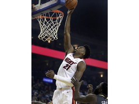 Miami Heat center Hassan Whiteside (21) shoots over Golden State Warriors' Draymond Green during the first half of an NBA basketball game, Sunday, Feb. 10, 2019, in Oakland, Calif.