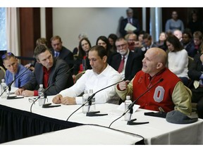 FILE - In this Nov. 16, 2018 file photo, victims of former Ohio State team doctor Dr. Richard Strauss, from right, Michael DiSabato, Mike Schyck, Brian Garrett and Stephen Snyder Hill speak during an Ohio State University Board of Trustees meeting at the Longaberger Alumni House in Columbus, Ohio. The men alleging Ohio State ignored or failed to stop sexual misconduct by the team doctor are recommending their lawsuits be handled by one of the mediation teams used in nationally known cases involving Michigan State and Penn State. But Ohio State says it won't agree to that because the handling of those cases led to controversy. The university is recommending that a former federal judge or a federal appeals court mediator be used instead in the two lawsuits against it.