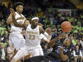 Buffalo's Dontay Caruthers (22) loses the ball while defended by Toledo's AJ Edu (15) and Willie Jackson (23) in the first half of an NCAA college basketball game, Friday, Feb. 15, 2019, in Toledo, Ohio.