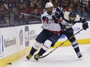 Washington Capitals' Alex Ovechkin, left, of Russia, and Columbus Blue Jackets' Seth Jones chase a loose puck during the first period of an NHL hockey game Tuesday, Feb. 12, 2019, in Columbus, Ohio.