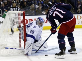 Tampa Bay Lightning goalie Andrei Vasilevskiy, left, of Russia, stops a shot by Columbus Blue Jackets forward Nick Foligno during the second period of an NHL hockey game in Columbus, Ohio, Monday, Feb. 18, 2019.