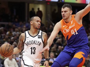 Brooklyn Nets' Shabazz Napier (13) drives past Cleveland Cavaliers' Ante Zizic (41), from Croatia, in the first half of an NBA basketball game, Wednesday, Feb. 13, 2019, in Cleveland.