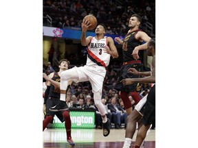 Portland Trail Blazers' CJ McCollum (3) drives to the basket against Cleveland Cavaliers' Ante Zizic (41), from Croatia, in the first half of an NBA basketball game, Monday, Feb. 25, 2019, in Cleveland.