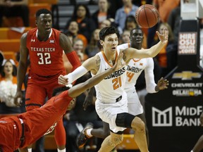 Texas Tech guard Jarrett Culver, left, and Oklahoma State guard Lindy Waters III (21) reach for the ball in the first half of an NCAA college basketball game in Stillwater, Okla., Wednesday, Feb. 13, 2019.