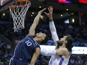 Memphis Grizzlies forward Ivan Rabb (10) reaches for a ball with Oklahoma City Thunder center Steven Adams, right, during the first half of an NBA basketball game in Oklahoma City, Thursday, Feb. 7, 2019.