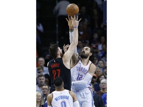 Portland Trail Blazers center Jusuf Nurkic (27) shoots as Oklahoma City Thunder center Steven Adams (12) defends in the first half of an NBA basketball game in Oklahoma City, Monday, Feb. 11, 2019.