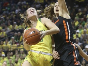 Oregon's Sabrina Ionescu, left, goes up to shoot against Oregon State's Mikayla Pivec during the second quarter of an NCAA college basketball game Friday, Feb. 15, 2019, in Eugene, Ore.