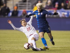 United States' Megan Rapinoe, right, tries to get around Japan's Risa Shimizu, left, with the ball during the first half of SheBelieves Cup soccer match, Wednesday, Feb. 27, 2019, in Chester, Pa.