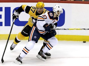 Pittsburgh Penguins' Sidney Crosby (87) defends against Edmonton Oilers' Connor McDavid (97) during the first period of an NHL hockey game in Pittsburgh, Wednesday, Feb. 13, 2019.