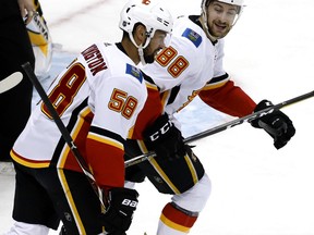 Calgary Flames' Andrew Mangiapane (88) celebrates his goal with Oliver Kylington (58) during the first period of an NHL hockey game against the Pittsburgh Penguins in Pittsburgh, Saturday, Feb. 16, 2019.