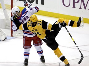 Pittsburgh Penguins' Evgeni Malkin (71) is upended by New York Rangers' Adam McQuaid (54) during the first period of an NHL hockey game in Pittsburgh, Sunday, Feb. 17, 2019.
