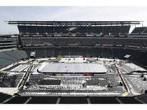 An insulated tarp covers the ice ahead of the NHL Winter Classic hockey game between the Pittsburgh Penguins and Philadelphia Flyers, in Philadelphia, Thursday, Feb. 21, 2019. When the Flyers host the Penguins on Saturday at Lincoln Financial Field, it'll be the 27th NHL outdoor game since 2003, and next season's Winter Classic is at the Cotton Bowl in Dallas. There's no fear of the variable climate in Texas in early January and almost no limit to where these games can go.