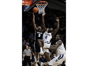 Providence's David Duke (3) shoots against Villanova's Eric Paschall (4) during the first half of an NCAA college basketball game, Wednesday, Feb. 13, 2019, in Villanova, Pa.