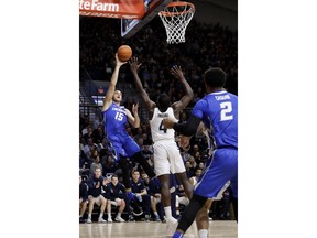 Creighton's Martin Krampelj (15) shoots as Villanova's Eric Paschall (4) defends during the first half of an NCAA college basketball game, Wednesday, Feb. 6, 2019, in Villanova, Pa.