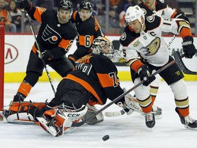 Philadelphia Flyers goalie Carter Hart sticks his leg out to block a scoring attempt by Anaheim Ducks' Ryan Getzal, right, during the first period of an NHL hockey game Saturday, Feb. 9, 2019, in Philadelphia. The Flyers won 6-2.