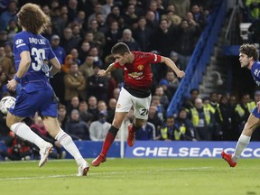 Manchester United's Ander Herrera, center, scores the opening goal of the game during the English FA Cup fifth round soccer match between Chelsea and Manchester United at Stamford Bridge stadium in London, Monday, Feb. 18, 2019.