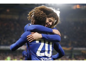 Chelsea's Callum Hudson-Odoi, with number 20, is hugged after scoring his side's third goal during the round of 32, second leg, Europa League soccer match between Chelsea and Malmo FF at Stamford Bridge stadium in London, Thursday Feb. 21, 2019.