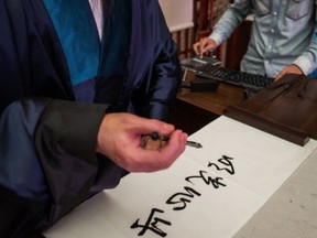 Upgrading a handwriting robot’s software at an exhibition in Guiyang, China.