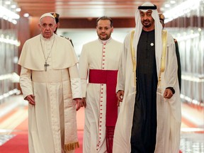 Pope Francis (C-L) is welcomed by Abu Dhabi's Crown Prince Sheikh Mohammed bin Zayed Al-Nahyan (C-R) upon his arrival at Abu Dhabi International Airport in the UAE capital on February 3, 2019. - Pope Francis arrived in the UAE on February 3 for the first ever papal visit to the Arabian Peninsula, birthplace of Islam, where he will hold an open-air mass for tens of thousands of Catholics.