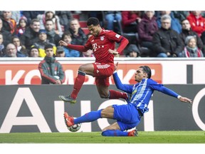 Munich's Serge Gnabry, left  and Hertha's Karim Rekik challenge for the ball during a German Bundesliga soccer match between Bayern Munich and Hertha BSC Berlinin Munich, Germany,Saturday, Feb.23, 2019.