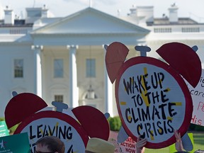 Protesters gather outside the White House to protest U.S. President Donald Trump's decision to withdraw the Unites States from the Paris climate accord in a file photo from June 1, 2017.