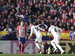 Real Madrid's Casemiro, centre, celebrates after scoring his sides 1st goal during a Spanish La Liga soccer match between Atletico Madrid and Real Madrid at the Metropolitano stadium in Madrid, Spain, Saturday, Feb. 9, 2019.