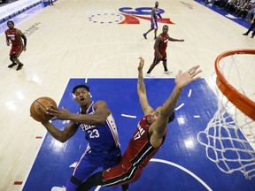 Philadelphia 76ers' Jimmy Butler (23) goes up for a shot against Miami Heat's Rodney McGruder (17) during the first half of an NBA basketball game Thursday, Feb. 21, 2019, in Philadelphia.