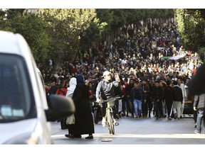 Demonstrators march in the streets of the Algerian capital, Algiers, to denounce President Abdelaziz Bouteflika's bid for a fifth term, Friday, Feb. 23, 2019. The 81-year-old Bouteflika announced this month that he plans to seek a new term in April presidential elections despite serious questions over his fitness for office after a 2013 stroke left him largely infirm.