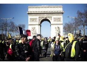 Yellow vest protesters gather at the Arc de Triomphe in Paris, France, Saturday, Feb. 23, 2019. French yellow vest protest organizers are trying to tamp down violence and anti-Semitism in the movement's ranks as they launch a 15th straight weekend of demonstrations.