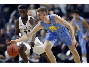 Marquette's Sam Hauser (10) battles Providence's Alpha Diallo (11) for a loose ball during the first half of an NCAA college basketball game in Providence, R.I., Saturday, Feb. 23, 2019.