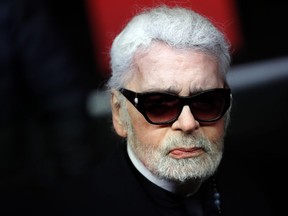 FILE - In this Thursday, Nov. 22, 2018 file photo, Fashion designer Karl Lagerfeld poses during the Champs Elysee Avenue illumination ceremony for the Christmas season, in Paris. Chanel says Tuesday, Feb. 19, 2019 its iconic couturier Karl Lagerfeld has died.