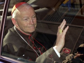 FILE - In this April 23, 2002 file photo Cardinal Theodore McCarrick of the Archdiocese of Washington, waves as he arrives at the Vatican in a limousine. On Saturday, Feb. 16, 2019 the Vatican announced Pope Francis defrocked former U.S. Cardinal Theodore McCarrick after Vatican officials found him guilty of soliciting for sex while hearing Confession.