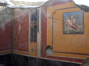 This undated photo provided Thursday, Feb. 14, 2019 by the Parco Archeologico di Pompei (Archeological Park of Pompei) shows the atrium of a house with a fresco portraying the mythological hunter Narcissus, right, in Pompeii, near Naples, Italy. Archaeologists have discovered a fresco in an ancient Pompeii residence that portrays the mythological hunter Narcissus, who fell in love with his own reflection, in a house where a fresco was found late last year depicting a sensual scene between the Roman god Jupiter disguised as a swan and Leda, a queen of Sparta from Greek mythology. (Parco Archeologico di Pompei via AP)