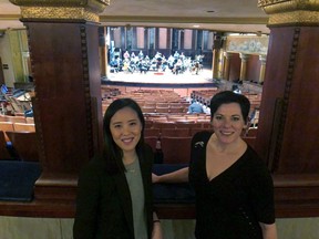 In this Jan. 28, 2019, photo Janet Chen, ProMusica Orchestra executive director, left, and Peggy Kriha Dye, general and artistic director for Opera Columbus, take a break during rehearsals for "The Flood," in Columbus, Ohio. The opera, a first-ever collaboration between the groups, tells the story of the disastrous 1913 Great Flood, one of the country's worst weather disasters.