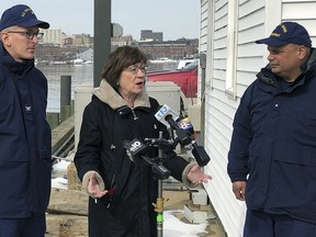 U.S. Sen. Susan Collins, R-Maine, is flanked by Coast Guard Capt. Brian LeFebvre, left, and Rear Adm. Andrew Tiongson, right, as she addresses reporters after the ribbon-cutting at a U.S. Coast Guard regional command center Wednesday, Feb. 20, 2019, in South Portland, Maine. Collins said that she would vote for a congressional resolution disapproving of President Donald Trump's emergency declaration to build a wall on the southern border. She is the first Republican senator to publicly express support for such a resolution.