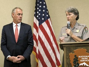 FILE - In this Oct. 13, 2017, file photo, then-Interior Secretary Ryan Zinke, left, and Grand Canyon National Park Superintendent Christine Lehnertz address National Park Service employees at Grand Canyon National Park, Ariz. Lehnertz is returning to work after being cleared in a federal investigation.
