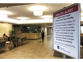 FILE - In this Jan. 25, 2019 file photo a sign prohibiting all children under 12 and unvaccinated adults stands at the entrance to PeaceHealth Southwest Medical Center in Vancouver, Wash. A measles outbreak that has sickened more than 40 people in the Pacific Northwest has prompted a call to eliminate a "philosophical" vaccine exemption that's resulted in 4 percent of children in Washington state to attend school without their routine childhood shots.